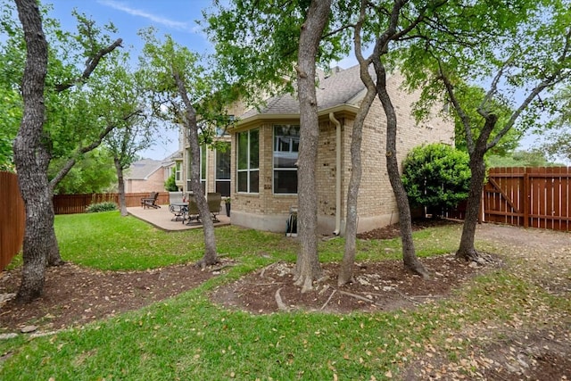 2418 Silent Brook Trl, Round Rock, TX 78665 - view of side of home featuring brick siding and a patio