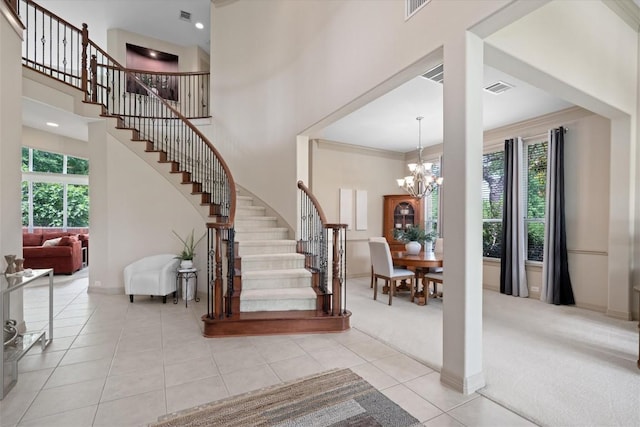 2418 Silent Brook Trl, Round Rock, TX 78665 - carpeted foyer entrance with stairway, tile patterned flooring, a high ceiling, a chandelier, and baseboards