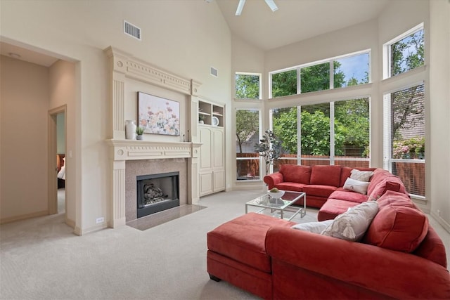 2418 Silent Brook Trl, Round Rock, TX 78665 - living area featuring high vaulted ceiling, carpet flooring, healthy amount of natural light, a fireplace with flush hearth, and baseboards