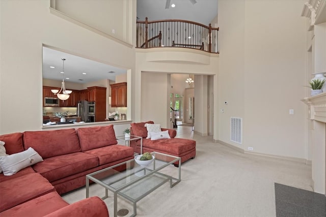 2418 Silent Brook Trl, Round Rock, TX 78665 - living room with a chandelier, light colored carpet, a towering ceiling, baseboards, and recessed lighting