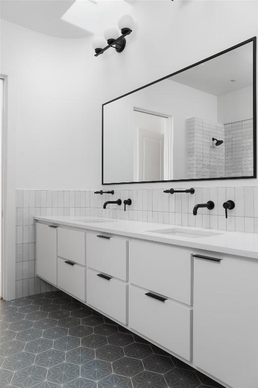 2709 Addison Ave, Austin, TX 78757 - full bath with tile walls, a sink, double vanity, and a tile shower