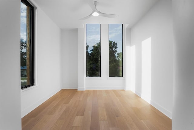 2709 Addison Ave, Austin, TX 78757 - spare room with light wood-style floors, a wealth of natural light, a ceiling fan, and baseboards