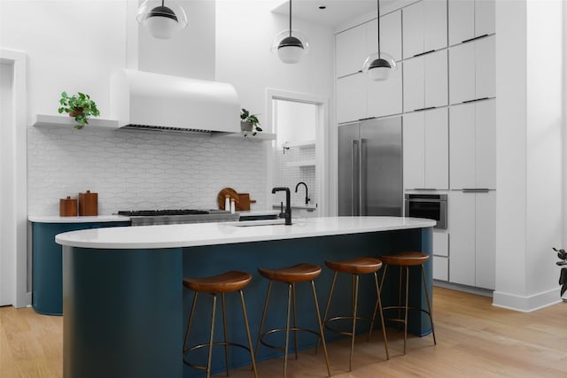 2709 Addison Ave, Austin, TX 78757 - kitchen featuring open shelves, a breakfast bar, stainless steel appliances, and modern cabinets