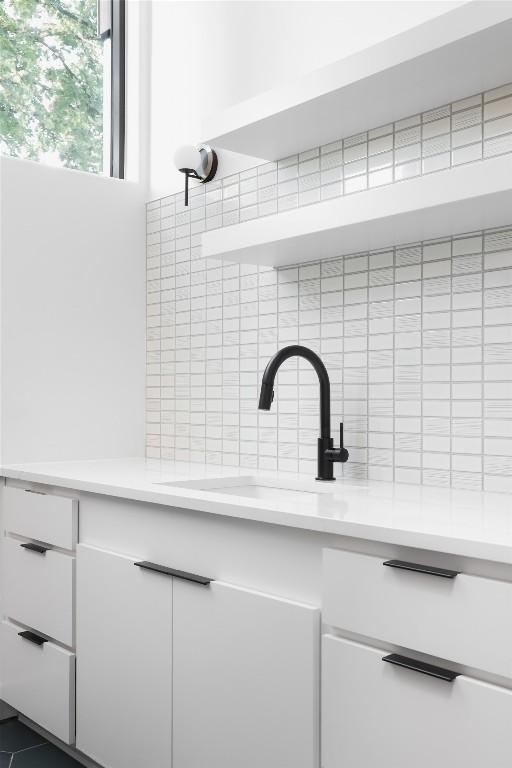 2709 Addison Ave, Austin, TX 78757 - details featuring decorative backsplash and a sink