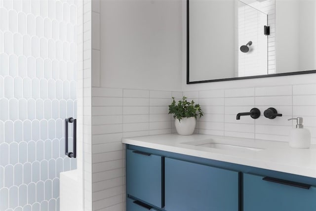 2709 Addison Ave, Austin, TX 78757 - bathroom featuring backsplash, tile walls, vanity, and a stall shower