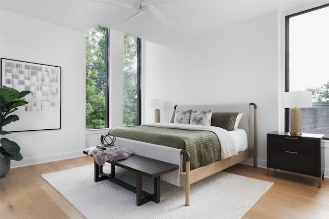 2709 Addison Ave, Austin, TX 78757 - bedroom with light wood finished floors, a ceiling fan, and multiple windows