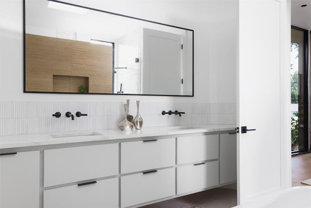 2709 Addison Ave, Austin, TX 78757 - full bathroom with decorative backsplash, walk in shower, a sink, and double vanity