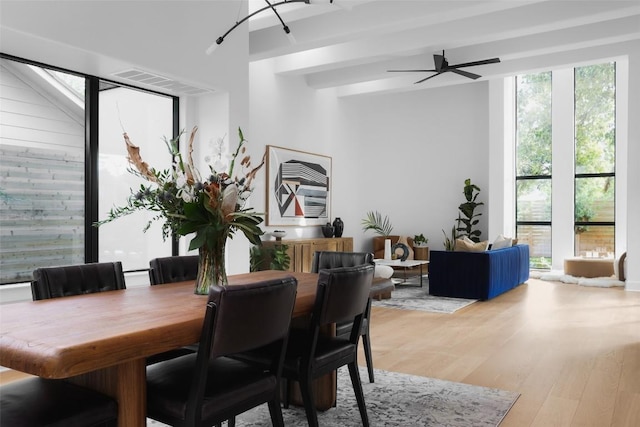 2709 Addison Ave, Austin, TX 78757 - dining space with ceiling fan, beamed ceiling, visible vents, and light wood-type flooring