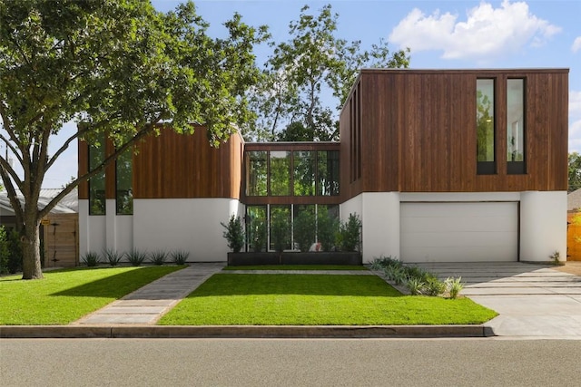 2709 Addison Ave, Austin, TX 78757 - modern home featuring a garage, a front lawn, and concrete driveway