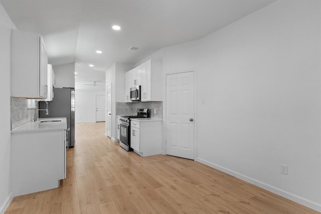 8121 Almondsbury Ln, Austin, TX 78748 - kitchen featuring appliances with stainless steel finishes, tasteful backsplash, light wood-type flooring, baseboards, and recessed lighting
