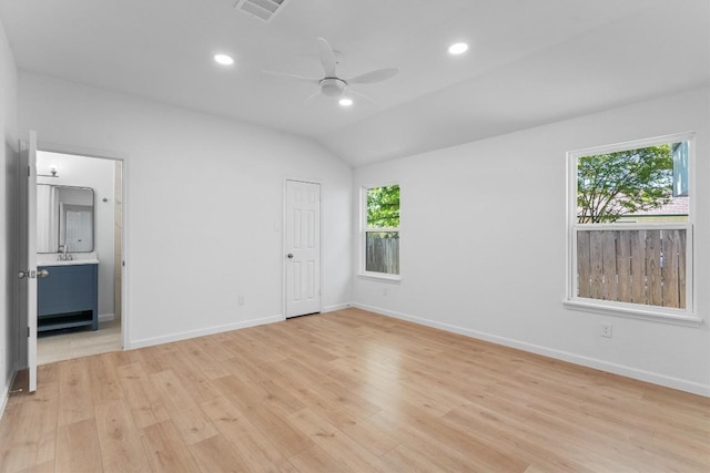 8121 Almondsbury Ln, Austin, TX 78748 - unfurnished bedroom featuring light wood-style flooring, baseboards, recessed lighting, connected bathroom, and vaulted ceiling