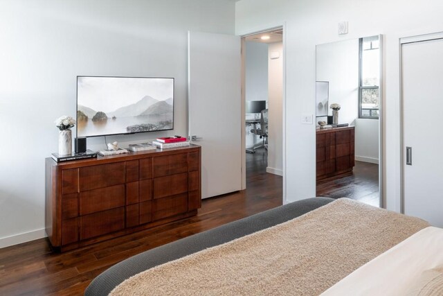 bedroom featuring baseboards and wood finished floors