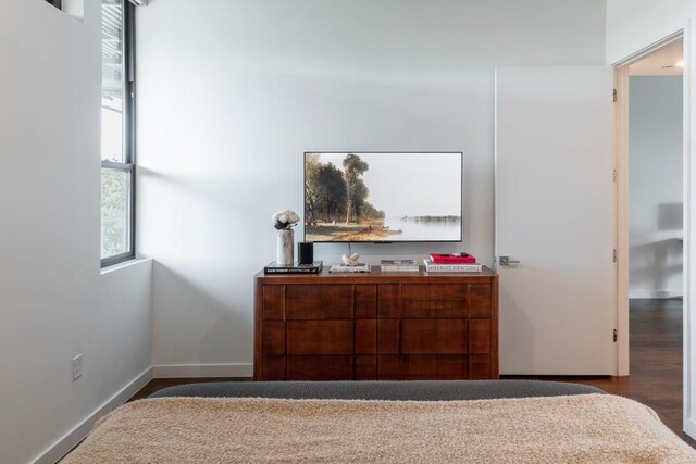 bedroom with baseboards and wood finished floors