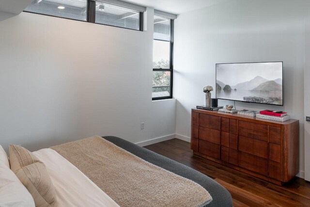 bedroom featuring baseboards and wood finished floors
