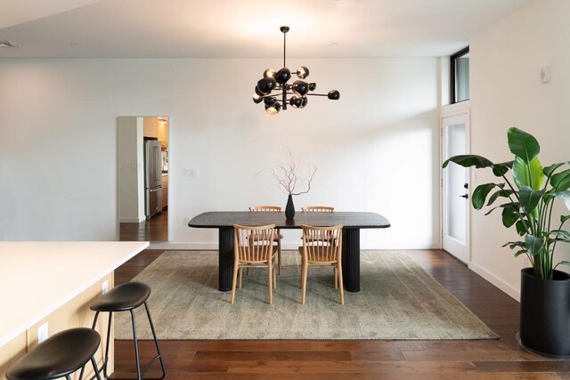 dining space with visible vents, baseboards, dark wood-style floors, and a chandelier