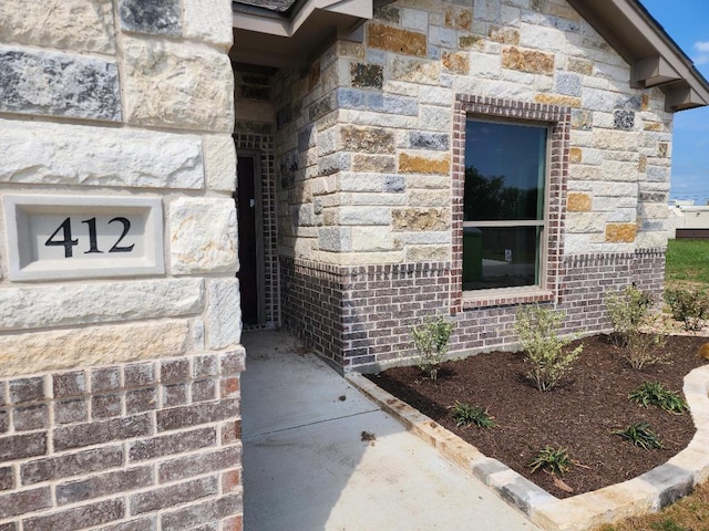 doorway to property with stone siding