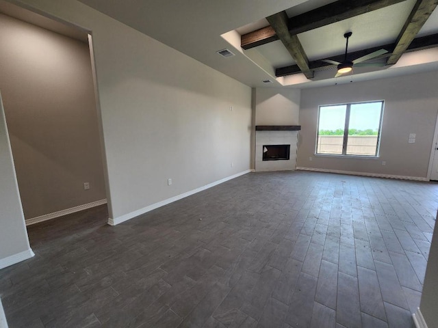unfurnished living room with visible vents, a ceiling fan, baseboards, and dark wood-style flooring