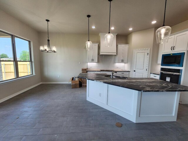 kitchen with white cabinets, oven, baseboards, recessed lighting, and black microwave