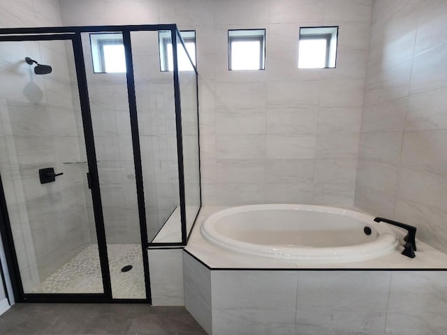 full bathroom with a garden tub and a stall shower