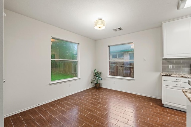400 W Tudor House Rd, Pflugerville, TX 78660 - unfurnished dining area with dark wood-type flooring