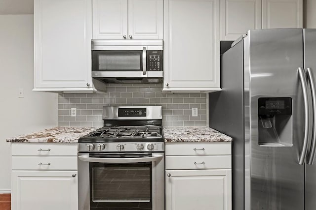 400 W Tudor House Rd, Pflugerville, TX 78660 - kitchen featuring stainless steel appliances, decorative backsplash, and white cabinetry