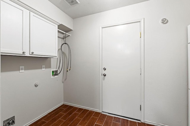 400 W Tudor House Rd, Pflugerville, TX 78660 - laundry room with dark wood-style flooring, cabinet space, washer hookup, and hookup for a gas dryer