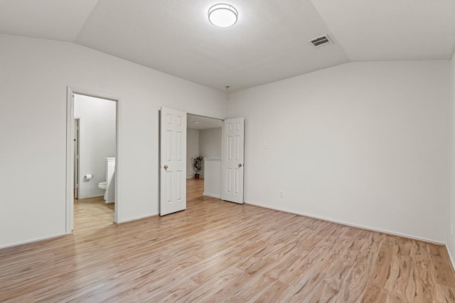 400 W Tudor House Rd, Pflugerville, TX 78660 - unfurnished bedroom with vaulted ceiling, light wood-type flooring, and ensuite bathroom