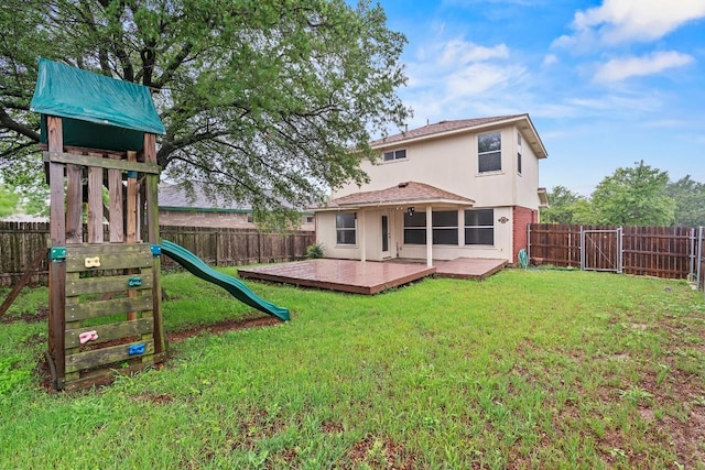 400 W Tudor House Rd, Pflugerville, TX 78660 - back of property featuring a fenced backyard, a wooden deck, roof with shingles, and stucco siding