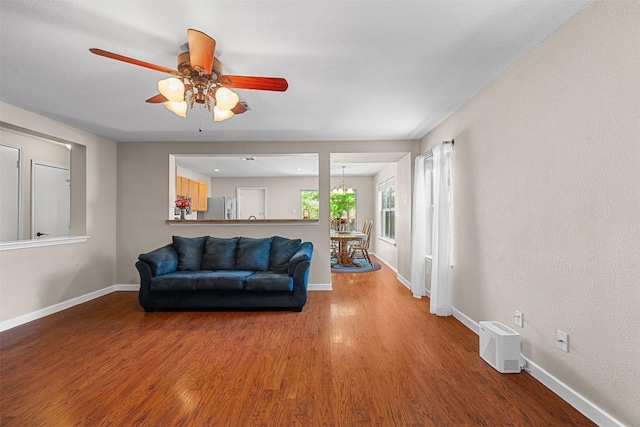 4302 Kings Canyon Dr, Taylor, TX 76574 - living area with baseboards, a ceiling fan, and wood finished floors