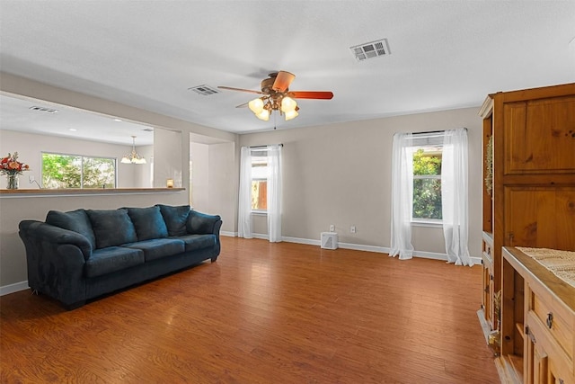 4302 Kings Canyon Dr, Taylor, TX 76574 - living area with light wood-type flooring, visible vents, a ceiling fan, and baseboards