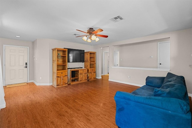 4302 Kings Canyon Dr, Taylor, TX 76574 - living area featuring wood finished floors, visible vents, baseboards, and ceiling fan