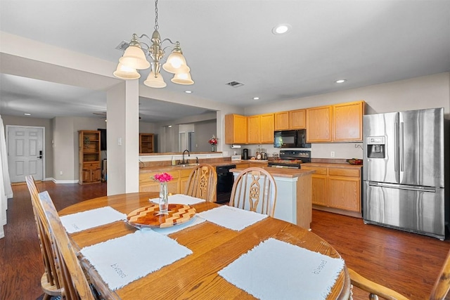 4302 Kings Canyon Dr, Taylor, TX 76574 - dining space with wood finished floors, an inviting chandelier, baseboards, visible vents, and recessed lighting