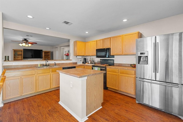 4302 Kings Canyon Dr, Taylor, TX 76574 - kitchen featuring light brown cabinets, electric stove, a sink, black microwave, and stainless steel fridge with ice dispenser