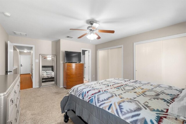 4302 Kings Canyon Dr, Taylor, TX 76574 - bedroom with ceiling fan, visible vents, light colored carpet, and multiple closets