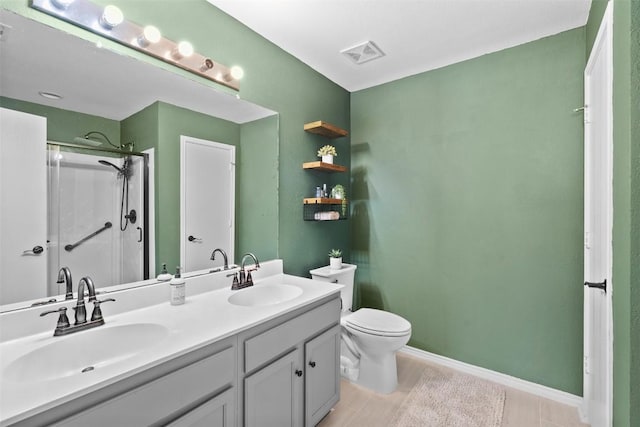 4302 Kings Canyon Dr, Taylor, TX 76574 - bathroom featuring a shower with shower door, visible vents, toilet, and a sink