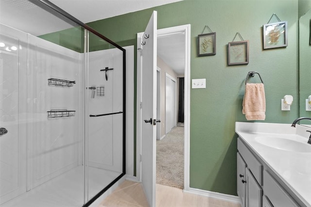 4302 Kings Canyon Dr, Taylor, TX 76574 - full bathroom featuring a textured wall, vanity, and a shower stall