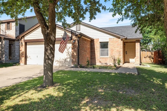 4302 Kings Canyon Dr, Taylor, TX 76574 - view of front of house with concrete driveway, an attached garage, fence, a front yard, and brick siding