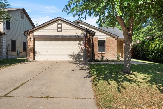 4302 Kings Canyon Dr, Taylor, TX 76574 - single story home featuring concrete driveway, an attached garage, brick siding, and a front lawn