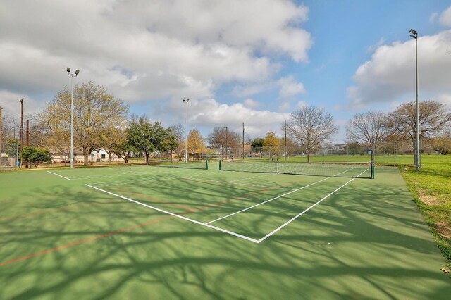 view of sport court featuring fence