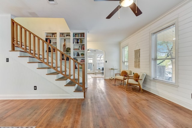 1606 W 14th St, Austin, TX 78703 - staircase featuring wood finished floors, ceiling fan, arched walkways, baseboards, and ornamental molding