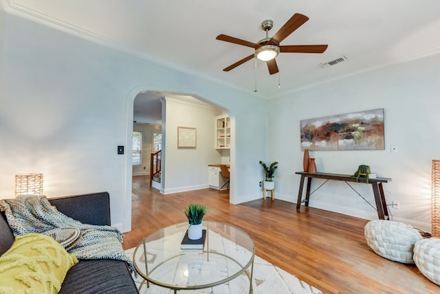 1606 W 14th St, Austin, TX 78703 - living area featuring arched walkways, ceiling fan, wood finished floors, ornamental molding, and baseboards