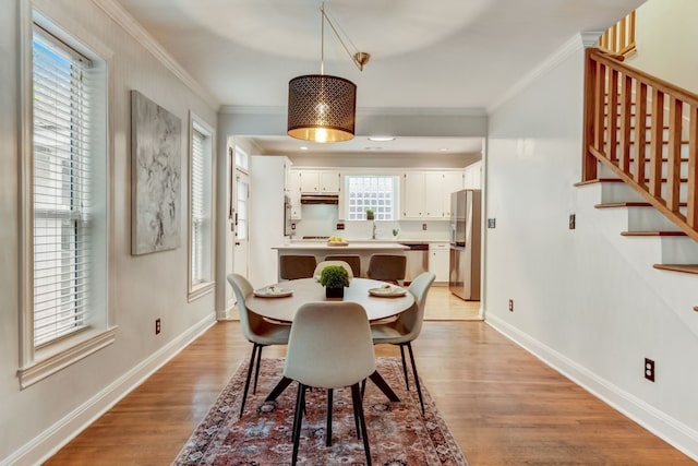 1606 W 14th St, Austin, TX 78703 - dining room with light wood-style floors, ornamental molding, stairs, and baseboards