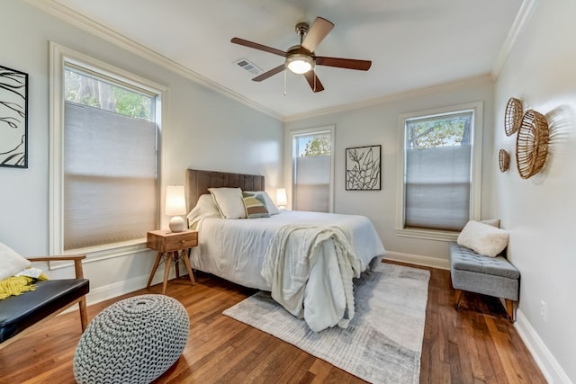 1606 W 14th St, Austin, TX 78703 - bedroom with ornamental molding, hardwood / wood-style floors, multiple windows, baseboards, and ceiling fan