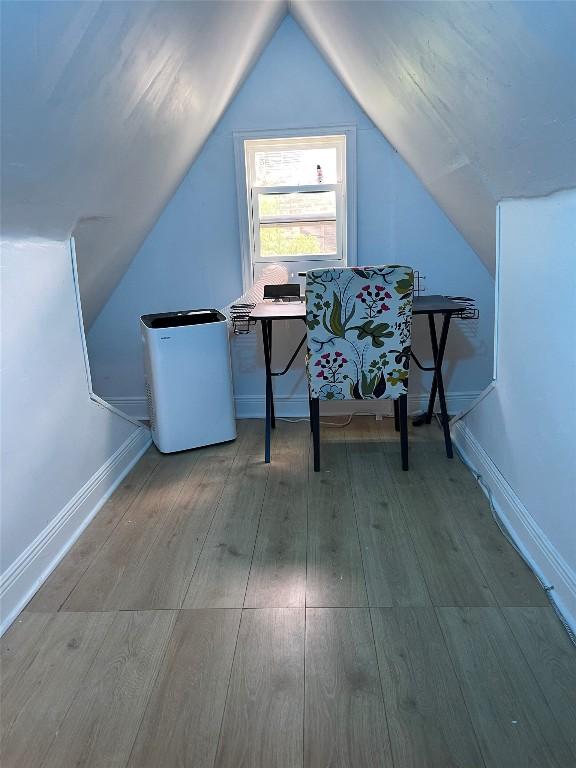 1606 W 14th St, Austin, TX 78703 - additional living space featuring wood finished floors, lofted ceiling, and baseboards