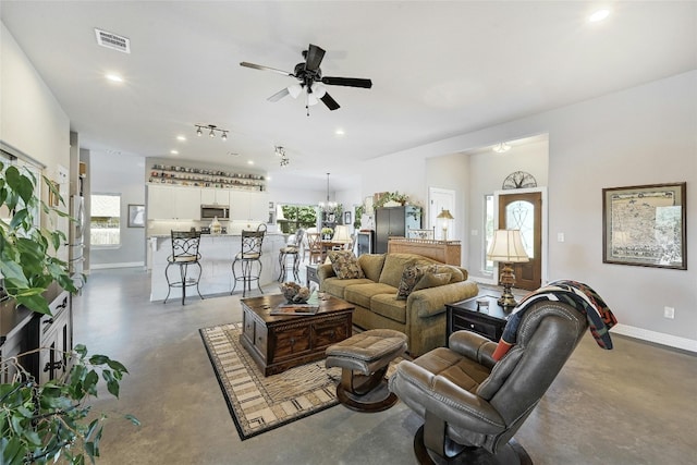 19908 Victoria Chase Rd, Lago Vista, TX 78645 - living area with finished concrete floors, ceiling fan, and recessed lighting