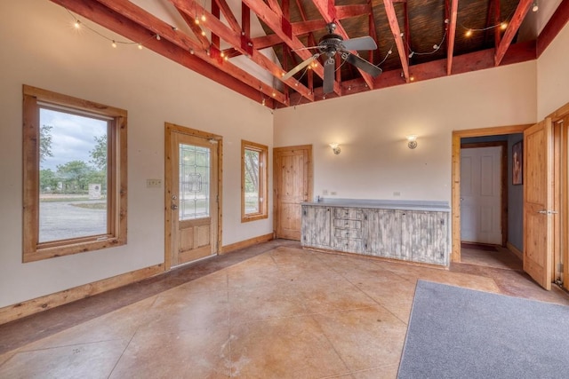 19908 Victoria Chase Rd, Lago Vista, TX 78645 - spare room featuring a high ceiling, healthy amount of natural light, a ceiling fan, and beam ceiling