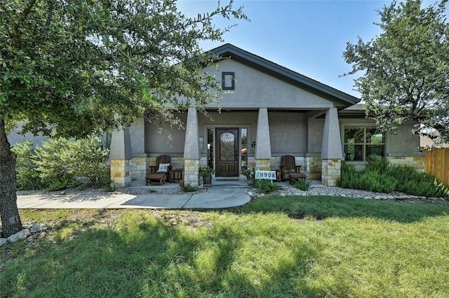 19908 Victoria Chase Rd, Lago Vista, TX 78645 - craftsman inspired home with stone siding, covered porch, stucco siding, and a front lawn