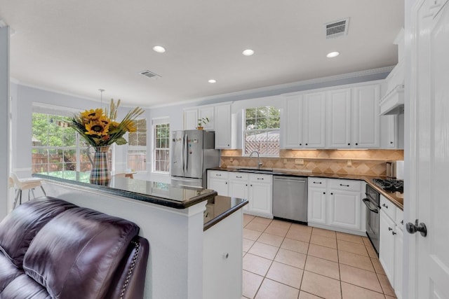 10020 Lachlan Dr, Austin, TX 78717 - kitchen with dark countertops, visible vents, appliances with stainless steel finishes, and a sink