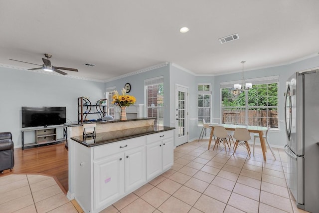 10020 Lachlan Dr, Austin, TX 78717 - kitchen with visible vents, dark countertops, freestanding refrigerator, and light tile patterned floors