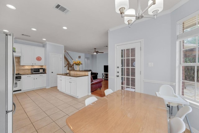 10020 Lachlan Dr, Austin, TX 78717 - kitchen featuring ornamental molding, appliances with stainless steel finishes, visible vents, and white cabinets